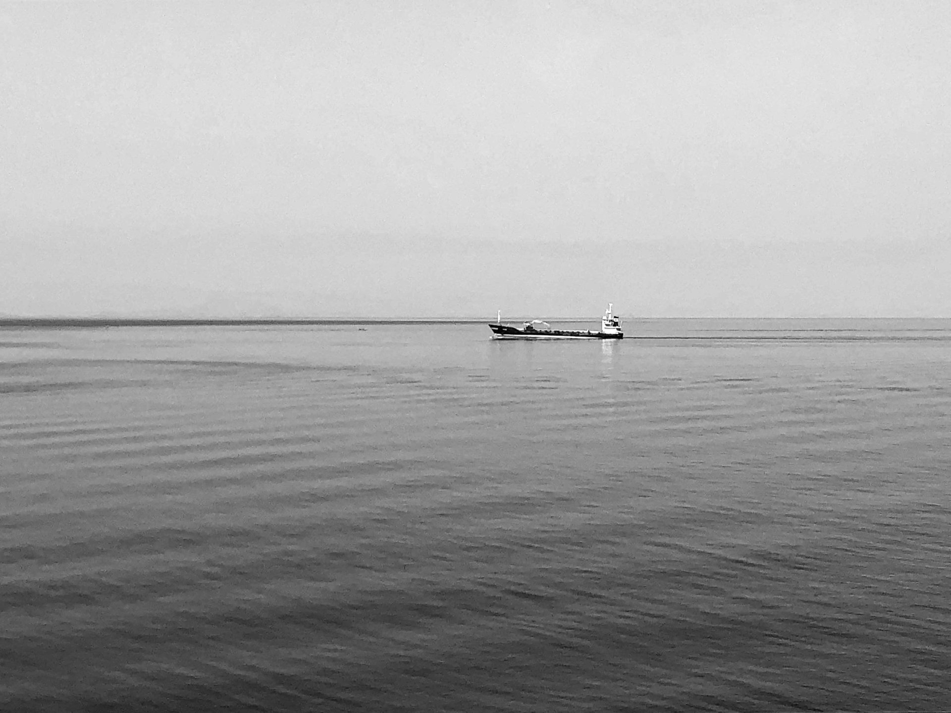 An ancient fishing boat anchored in the waters above Kolumbo